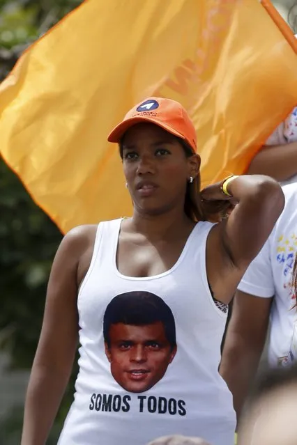 A supporter of jailed opposition leader Leopoldo Lopez, wears a t-shirt with Lopez's face as she attends  a campaign rally of deputies candidates for the National Assembly for the Venezuelan coalition of opposition parties Democratic Unity Roundtable (MUD), in Caracas, November 29, 2015. Venezuela will hold parliamentary elections on December 6. The words on the T-shirt read, "We are all". (Photo by Marco Bello/Reuters)
