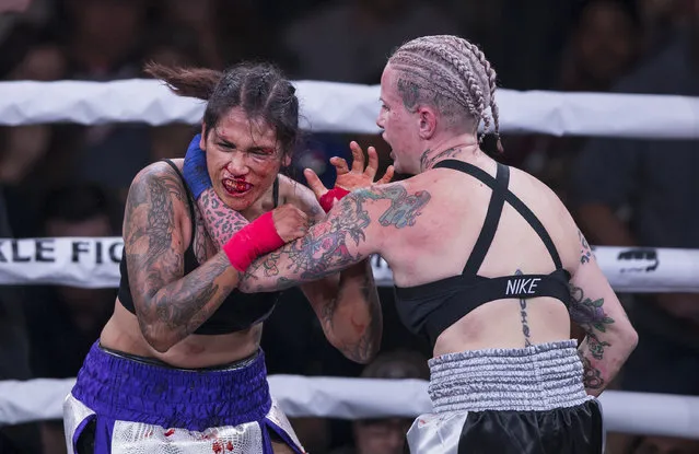 Alma Garcia, left, takes a hit from Bec Rawlings during a 125-pound bout at the Bare Knuckle Fighting Championship at the Ice and Events Center Saturday, June 2, 2018, in Cheyenne, Wyo. Rawlings won the bout. (Photo by Michael Smith/AP Photo)
