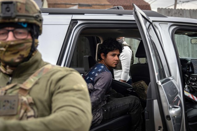 A person, who was brifley detained and later released by US Customs and Border Patrol (CBP) agents, sits handcuffed inside a car in Kenner, Louisiana, on December 3, 2025. The US Department of Homeland Security announced on Wednesday it has launched a federal immigration enforcement operation, named “Operation Catahoula Crunch”, in the New Orleans, Louisiana area. (Photo by Adam Gray/AFP Photo)