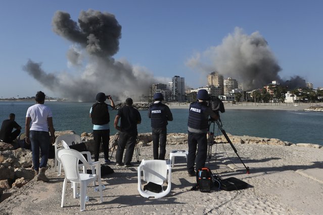 Journalists film as smoke rises from buildings hit in Israeli airstrikes in Tyre, southern Lebanon, Monday, October 28, 2024. (Photo by Mohammed Zaatari/AP Photo)