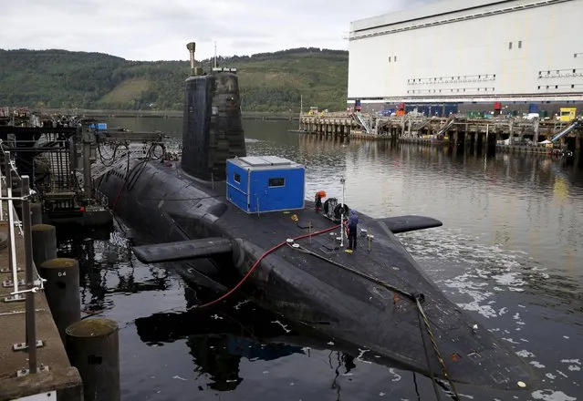 A nuclear submarine is seen at the Royal Navy's submarine base at Faslane, Scotland, August 31, 2015. The UK government is considering nationalising the nuclear submarine business of Rolls-Royce Holdings PLC, which powers its Trident missile deterrent system, the Financial Times reported. The government may also decide to merge some or all parts of Rolls Royce's businesses with BAE Systems, the FT said. (Photo by Russell Cheyne/Reuters)