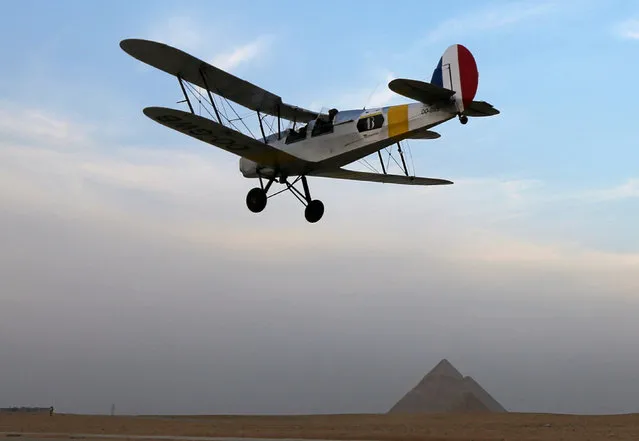 A biplane flown by Cedric Collette and Alexandra Maingard glides by Egypt's iconic pyramids of Giza, on the second leg of their month-long journey through Africa in Cairo, Egypt, November 13, 2016. (Photo by Mohamed Abd El Ghany/Reuters)