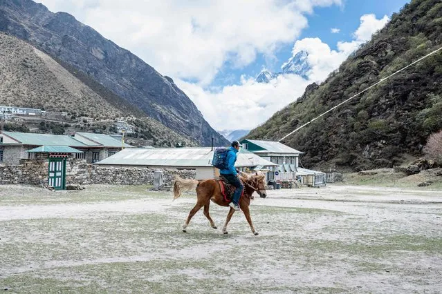 This picture taken on May 26, 2023 shows Phurba Tashi Sherpa, head of an expedition operator and guide, riding a horse during an interview with AFP at the village of Khumjung, located in the shadow of Mount Everest, some 140 kilometres (87 miles) northeast of Kathmandu. Veteran mountain guide Phurba Tashi Sherpa was born and raised in Khumjung, a village about 10 kilometres (6.2 miles) from base camp. He grew up watching his father and uncles go to the mountains for work, and soon joined them on expeditions, eventually climbing Everest 21 times before he retired. (Photo by Robic Upadhayay/AFP Photo)