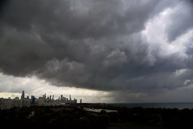 Storm clouds pass over downtown Chicago and the Bronzeville neighborhood of the city heading East out over Lake Michigan as the National Weather Service continued to issue multiple tornado warnings in the greater metropolitan area Wednesday, July 12, 2023. (Photo by Charles Rex Arbogast/AP Photo)