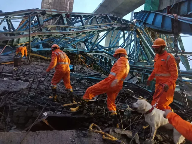 This photograph provided by India's National Disaster Response Force (NDRF) shows NDRF personnel on rescue operations after an accident at a bridge of under construction Samruddhi Expressway at Shahapur, Thane District, Maharashtra state, India, Tuesday, August 1, 2023. More than a dozen people are reported killed. (Photo by NDRF via AP Photo)