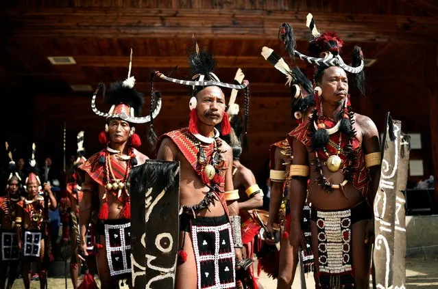 Tribal men dressed in traditional attire wait for their turn to perform a folk dance during the Hornbill Festival at Kisama village in the northeastern state of Nagaland, India December 1, 2016. (Photo by Anuwar Hazarika/Reuters)