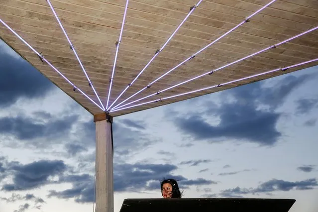 DJ Jubilee plays music at Elsewhere, a music venue and nightclub, at the reopening of the rooftop within restrictions amid the coronavirus disease (COVID-19) pandemic, in the Bushwick area of Brooklyn, New York, U.S., April 30, 2021. (Photo by Gaia Squarci/Reuters)