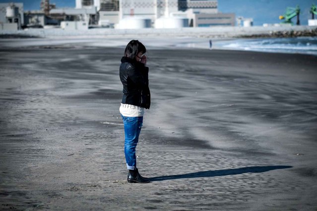 A young lady comes to the beach for pray at the time shock for 4th anniversary of the tsunami and nuke power plant Fukushima Dai-Ichi meltdown in Minami-Soma, Japan on March 11, 2015. (Photo by Datiche Nicolas/SIPA Press)