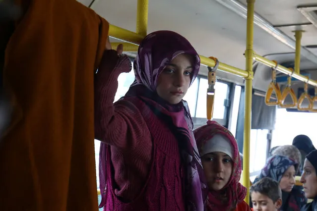 Evacuees from the Shi'ite Muslim villages of al-Foua and Kefraya ride a bus at insurgent-held al-Rashideen in the province of Aleppo, Syria December 22, 2016. (Photo by Ammar Abdullah/Reuters)