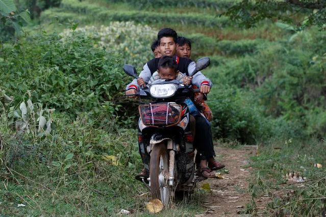 People drive their motor bike as they travel outside Pansang, Wa territory in northeast Myanmar October 3, 2016. (Photo by Soe Zeya Tun/Reuters)