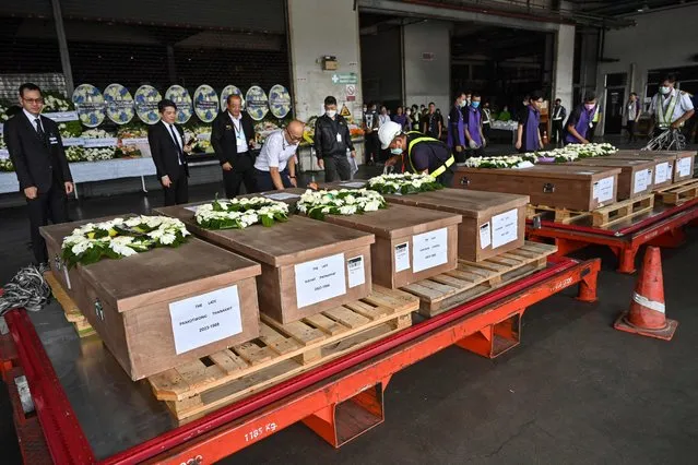 Coffins of 8 Thai workers killed in the conflict between Israel and Palestinian militant group Hamas are displayed after being repatriated from Israel during a ceremony at Suvarnabhumi airport in Bangkok on October 20, 2023. At least thirty Thais have been killed in the conflict and another 17 are thought to have been abducted. About 30,000 Thais work in Israel, most in the agricultural sector, according to government figures. (Photo by James Wilson/Pool via AFP Photo)