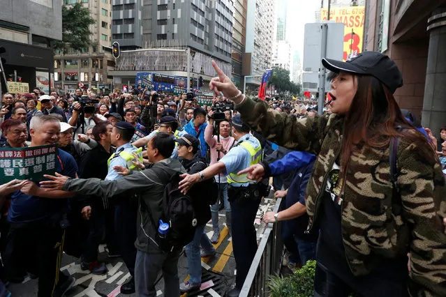 A pro-China protester (R) who is against Hong Kong independence argues with protesters taking part in a pro-democracy march in Hong Kong, China January 1, 2017. (Photo by Bobby Yip/Reuters)