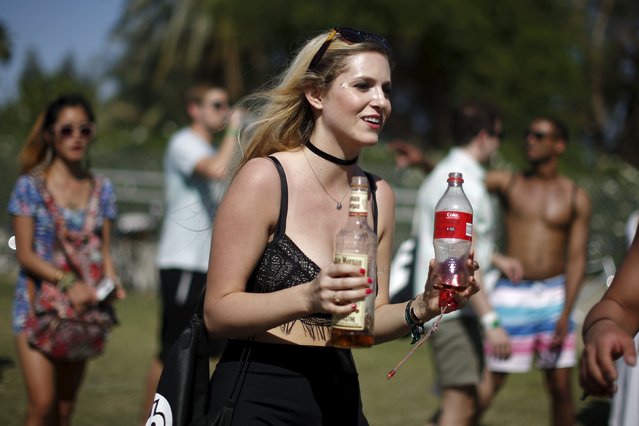 A woman carries bottles of rum and coke before entering the Coachella Valley Music and Arts Festival in Indio, California April 12, 2015. (Photo by Lucy Nicholson/Reuters)