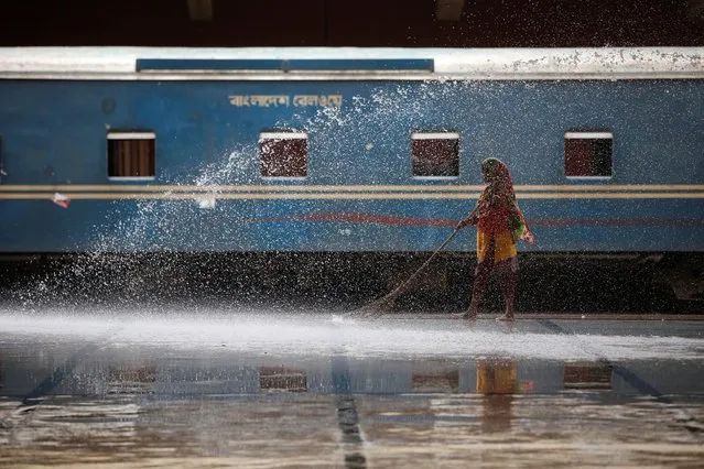 A woman cleans a platform at the Kamalapur Railway Station in Dhaka, Bangladesh, August 7, 2016. (Photo by Mohammad Ponir Hossain/Reuters)
