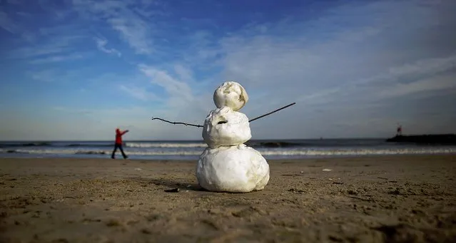 A snowman stands on the beach with temperatures around freezing near Rudee inlet in Virginia Beach, Va., on January 23, 2014. (Photo by L. Todd Spencer/The Virginian-Pilot)