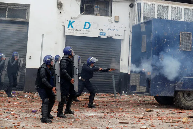 Anti-riot police officers clash with people protesting against President Abdelaziz Bouteflika, in Algiers, Algeria March 8, 2019. The graffiti reads : “no to the fifth Term”. (Photo by Zohra Bensemra/Reuters)