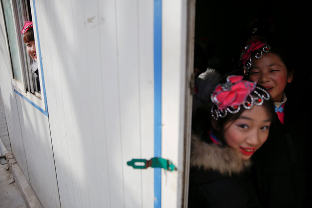 Performers share a light moment before going onto the stage at the Longtan park as the Chinese Lunar New Year, which welcomes the Year of the Rooster, is celebrated in Beijing, China January 29, 2017. (Photo by Damir Sagolj/Reuters)
