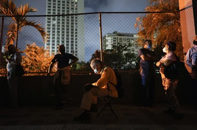 Residents wait at dawn outside a vaccination center in hopes of getting a second shot of the Sputnik V COVID-19 vaccine in Caracas, Venezuela, Friday, September 17, 2021. (Photo by Ariana Cubillos/AP Photo)