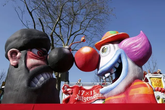 A carnival float with papier-mache caricatures featuring a clown facing an fighter of the Islamic State (IS) is displayed at a postponed “Rosenmontag” (Rose Monday) parade, at one location in Duesseldorf, Germany, March 13, 2016, after the original parade in February was cancelled due to severe weather. (Photo by Ina Fassbender/Reuters)