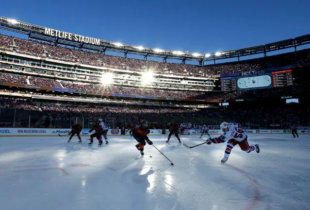 New York Rangers defenseman Erik Gustafsson (56) takes a shot against New York Islanders defenseman Alexander Romanov (28) and goaltender Ilya Sorokin (30) during the first period of a Stadium Series ice hockey game at MetLife Stadium in East Rutherford, New Jersey on February 18, 2024. (Photo by Brad Penner/USA TODAY Sports)