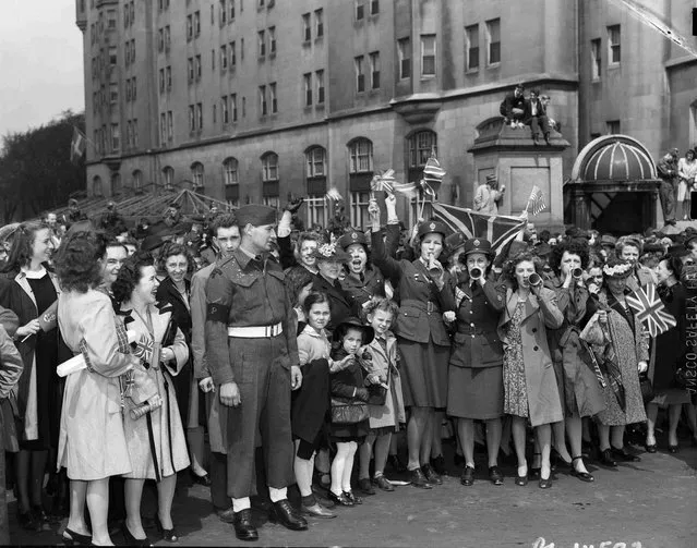 A crowd celebrates at the Victory Loan Indicator, Confederation Square, on VE-Day in Ottawa, Ontario, May 8, 1945, in this handout photo provided by Library and Archives Canada. (Photo by Chris Lund/Reuters/National Film Board of Canada/Library and Archives Canada)