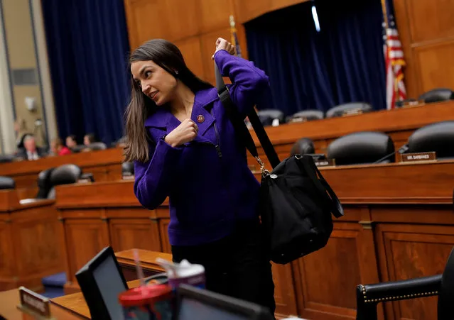 U.S. Rep. Alexandria Ocasio-Cortez (D-NY) picks up her bag and departs after she and the House Oversight and Reform Committee voted to subpoena the White House about security clearances while meeting on Capitol Hill in Washington, U.S., April 2, 2019. (Photo by Carlos Barria/Reuters)