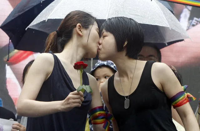 Same-s*x marriage supporters kiss outside the Legislative Yuan Friday, May 17, 2019, in Taipei, Taiwan after the legislature passed a law allowing same-s*x marriage in a first for Asia. The vote Friday allows same-s*x couples full legal marriage rights, including in areas such as taxes, insurance and child custody. (Photo by Chiang Ying-ying/AP Photo)
