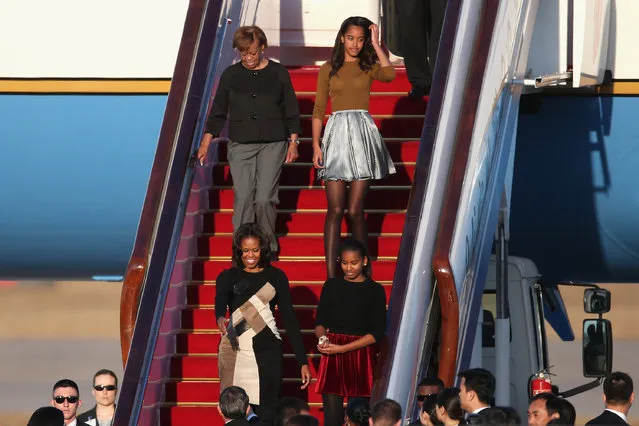 First Lady Michelle Obama with her mother Marian Robinson, daughters Sasha Obama and Malia Obama arrives at Beijing Capital International Airport on March 20, 2014 in Beijing, China. The first lady arrived in Beijing with her mother, Marian Robinson, and daughters to kick off a six-day tour where she will focus on education and cultural exchange. (Photo by Feng Li/Getty Images)