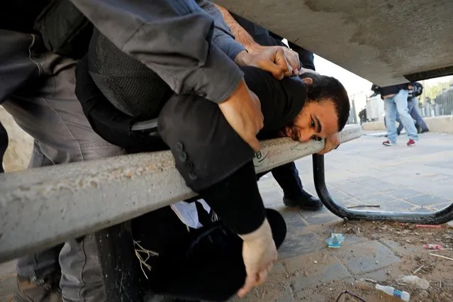 Policemen detain an Ultra-Orthodox Jew during a protest over the coronavirus disease (COVID-19) restrictions in Ashdod, Israel, January 24, 2021. (Photo by Amir Cohen/Reuters)