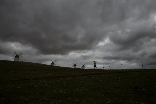 Fernando Ortega, 40, runs past the windmills in Alcazar de San Juan, Spain, April 5, 2016. (Photo by Susana Vera/Reuters)