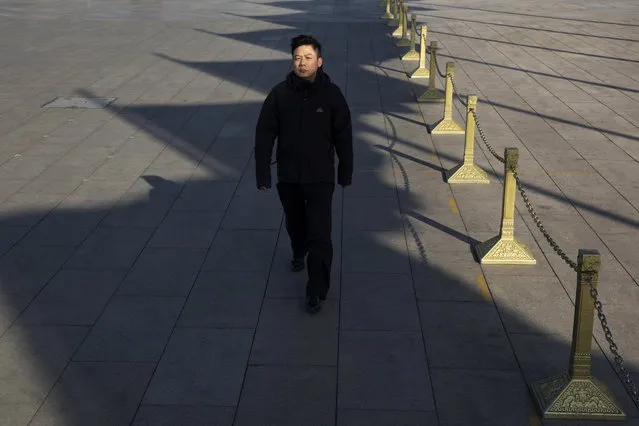 In this photo taken Wednesday, March 8, 2017, a participant arrives near the Great Hall of the People where a plenary session of the National People's Congress is held in Beijing, China. (Photo by Ng Han Guan/AP Photo)