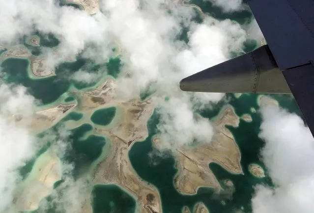 Lagoons can be seen from a plane as it flies above Kiritimati Island, part of the Pacific Island nation of Kiribati, April 5, 2016. (Photo by Lincoln Feast/Reuters)