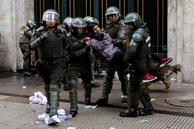 A student protester is detained outside the education ministry building during a rally to demand changes in the education system in Santiago, Chile April 28, 2016. (Photo by Ivan Alvarado/Reuters)