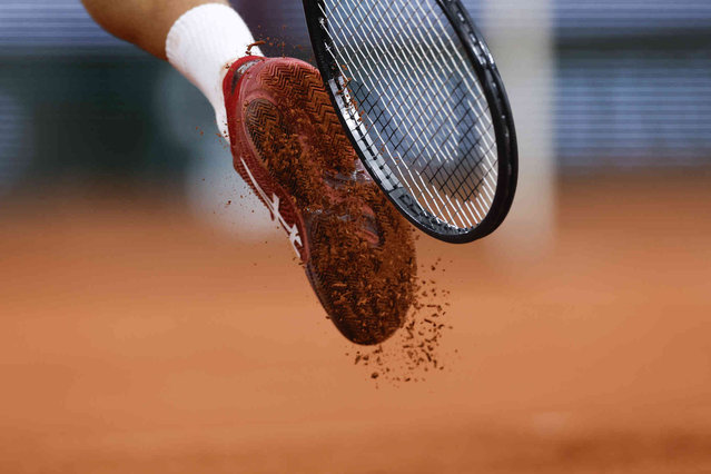 Serbia's Novak Djokovic taps the clay off his shoes during his second round match of the French Open tennis tournament against Spain's Roberto Carballes Baena at the Roland Garros stadium in Paris, Thursday, May 30, 2024. (Photo by Jean-Francois Badias/AP Photo)