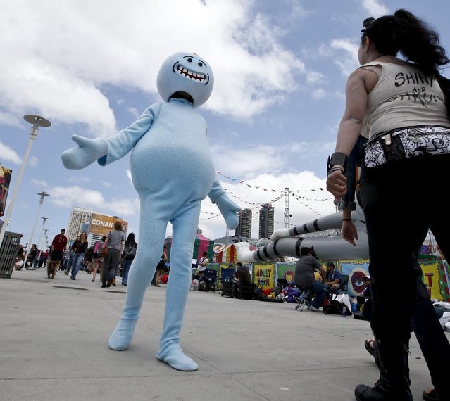 Characters in costume greet each other on opening day of the 2015 Comic-Con International Thursday, July 9, 2015, in San Diego. (Photo by Lenny Ignelzi/AP Photo)