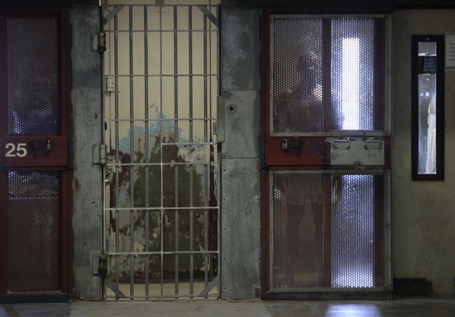 An inmate looks out from his cell in the Security Housing Unit (SHU) at Corcoran State Prison in Corcoran, California October 1, 2013. (Photo by Robert Galbraith/Reuters)
