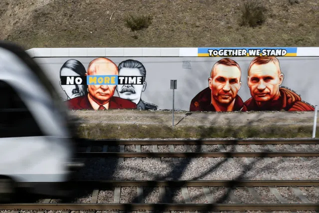 Murals showing Ukrainian brothers Klitschko “Together we stand” (R) and Hitler, Putin and Stalin “No more time” (L) created by graffiti artist Tuse, is sprayed on a wall n Gdansk, northern Poland, 22 March 2022. On 24 February Russian troops had entered Ukrainian territory in what the Russian president declared a “special military operation”, resulting in fighting and destruction in the country, a huge flow of refugees, and multiple sanctions against Russia. (Photo by Adam Warzawa/EPA/EFE)