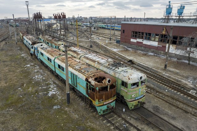 As seen from an aerial view, war damaged locomotive engines stand in a rail yard on March 01, 2023 in Lyman, Ukraine. The strategic town, with its sprawling rail junction was a key prize for invading Russian forces as a main Donbas logistics hub, but after a month of fierce fighting, it was liberated by Ukrainian forces in early October 2022. (Photo by John Moore/Getty Images)