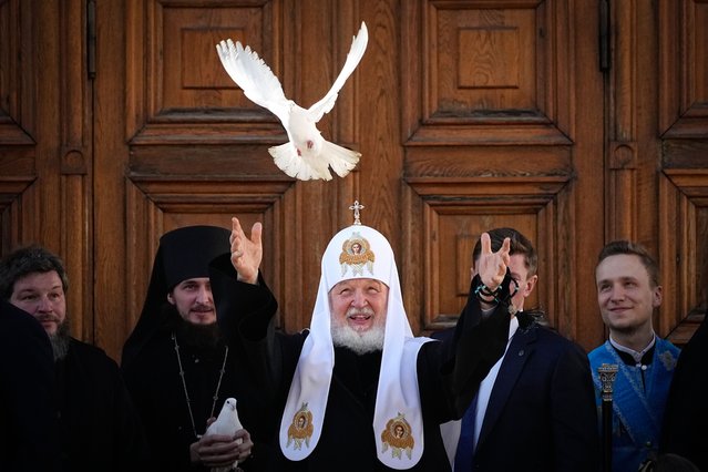 Russian Orthodox Church Patriarch Kirill releases a bird celebrating the Annunciation preceding the celebration of Orthodox Easter in front of the Annunciation Cathedral in the Moscow Kremlin, in Moscow, Russia, Friday, April 7, 2023. (Photo by Alexander Zemlianichenko/AP Photo)