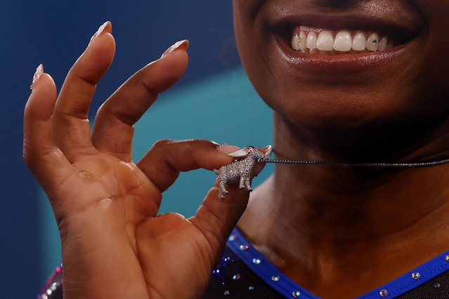 US gymnast Simone Biles shows off a goat necklace after winning Olympic gold in the individual all-around event on Thursday, August 1, 2024. Many consider Biles to be the GOAT: greatest of all time. She has won more Olympic medals than any other US gymnast in history. (Photo by Hannah McKay/Reuters)