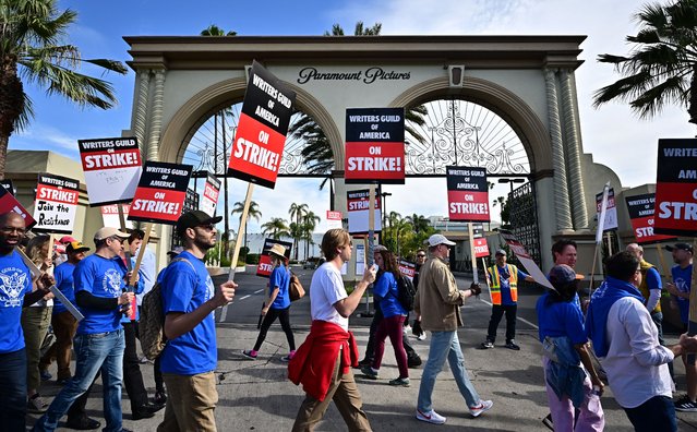 Writers walk the picket line on the second day of the television and movie writers' strike outside of Paramount Studios in Los Angeles, California on May 3, 2023. More than 11,000 Hollywood television and movie writers went on their first strike in 15 years, after talks with studios and streamers over pay and working conditions failed to clinch a deal. The strike means late-night shows are expected to grind to a halt immediately, while television series and movies scheduled for release later this year and beyond could face major delays. (Photo by Frederic J. Brown/AFP Photo)