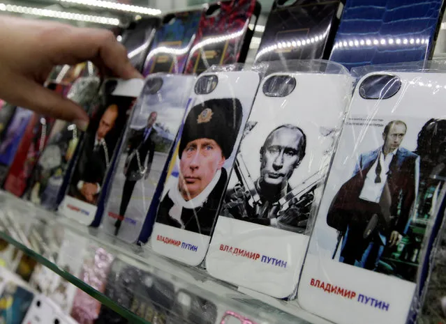 Mobile phones cases displaying images of Russian President Vladimir Putin, are pictured on display at an electronic store in Stavropol, southern Russia, February 12, 2015. (Photo by Eduard Korniyenko/Reuters)