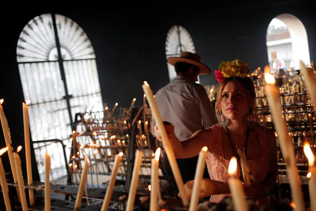 Pilgrims light candles during a pilgrimage in the shrine of El Rocio in Almonte, southern Spain June 2, 2017. (Photo by Jon Nazca/Reuters)