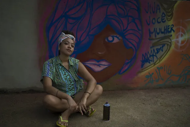 Maiara Viana Rodrigues poses in front of her mural in Rio de Janeiro, Brazil, March 7, 2017 photo. Female artists say they don't just want to put a light on physical violence, but also psychological abuse, unequal access to education and health care and the fact that women often earn less to do the same job as men. (Photo by Leo Correa/AP Photo)