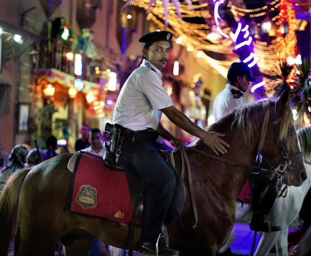 In this Sunday, June 5, 2016 photo, an Egyptian policeman patrols El-Moez Street in historical Fatimid Cairo, as people mark the first day of the holy month of Ramadan in Cairo, Egypt. Devout Muslims throughout the world began to celebrate Ramadan, the holiest month in the Islamic calendar, refraining from eating, drinking, smoking and s*x from sunrise to sunset. (Photo by Amr Nabil/AP Photo)