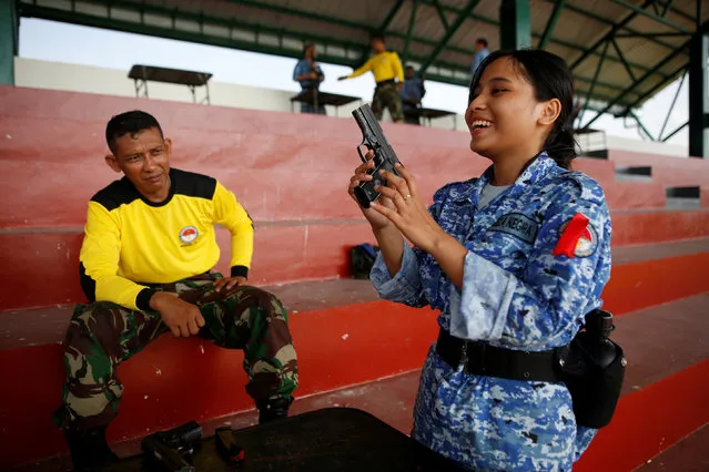 A military trainer helps a participant of the Bela Negara – “defend the nation” – programme with weapons familiarisation at a training centre in Rumpin, Bogor, West Java, Indonesia June 2, 2016. (Photo by Darren Whiteside/Reuters)