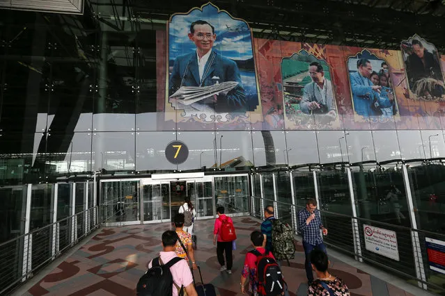 People are seen at Suvarnabhumi Airport, which is decorated with pictures of Thailand's King Bhumibol Adulyadej, in Bangkok, Thailand, April 2, 2016. (Photo by Jorge Silva/Reuters)