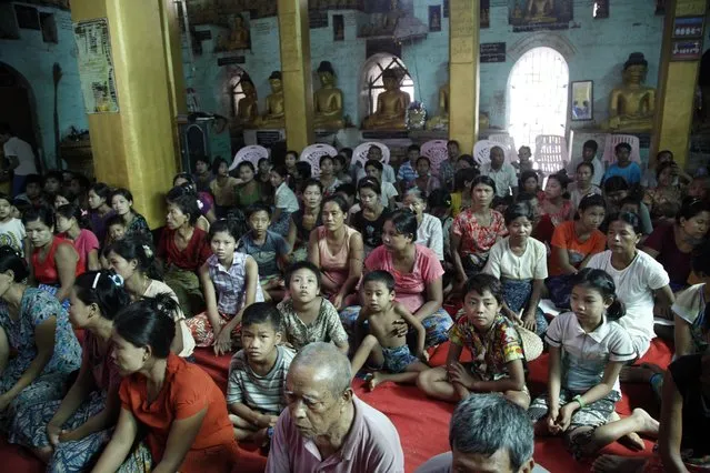 Flood victims gather inside a monastery, opened as a temporary relief camp, in Myauk U, Rakhine State, western Myanmar, Tuesday, August 4, 2015. (Photo by Khin Maung Win/AP Photo)