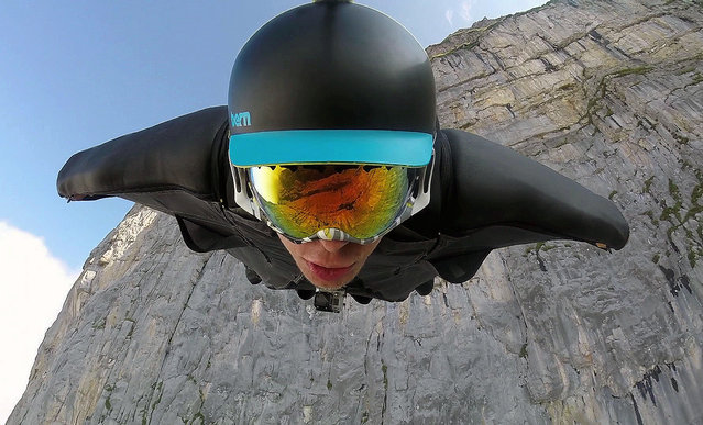 Brandon had been planning the flight for many weeks, on August 8, 2014, in Walenstadt, Switzerland. Soaring over trees and narrowly avoiding cliff tops, a wing-suiter flies through stunning countryside at 130mph. Brandon Mikesell, 27, from Seattle, was taking on the famous “Barn Line” in Walenstadt, in Switzerland.The notorious route is only suitable for bigger suits that have more speed, lift and range- and takes daredevils dangerously close to trees and through clouds. Reaching speeds of 130mph, Brandon successfully soared 2.5 miles in just one-and-a-half minutes before landing in a farmer's field. (Photo by Brandon Mikesell/Barcroft Media)