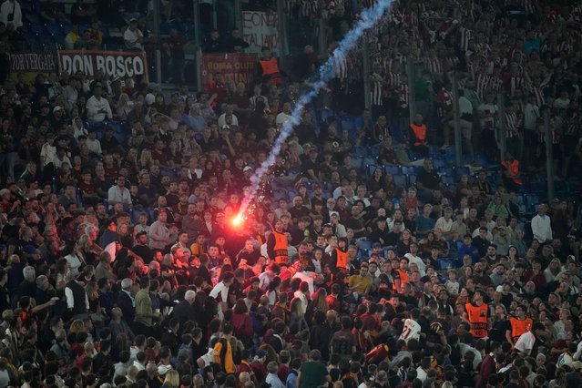 A flare is thrown towards Roma's fans sector, after Athletic Bilbao's Aitor Paredes scored his side's first goal during the Europa League opening phase soccer match between Roma and Athletic Club at the Stadio Olimpico in Rome, Italy, Thursday, September 26, 2024. (Photo by Alessandra Tarantino/AP Photo)